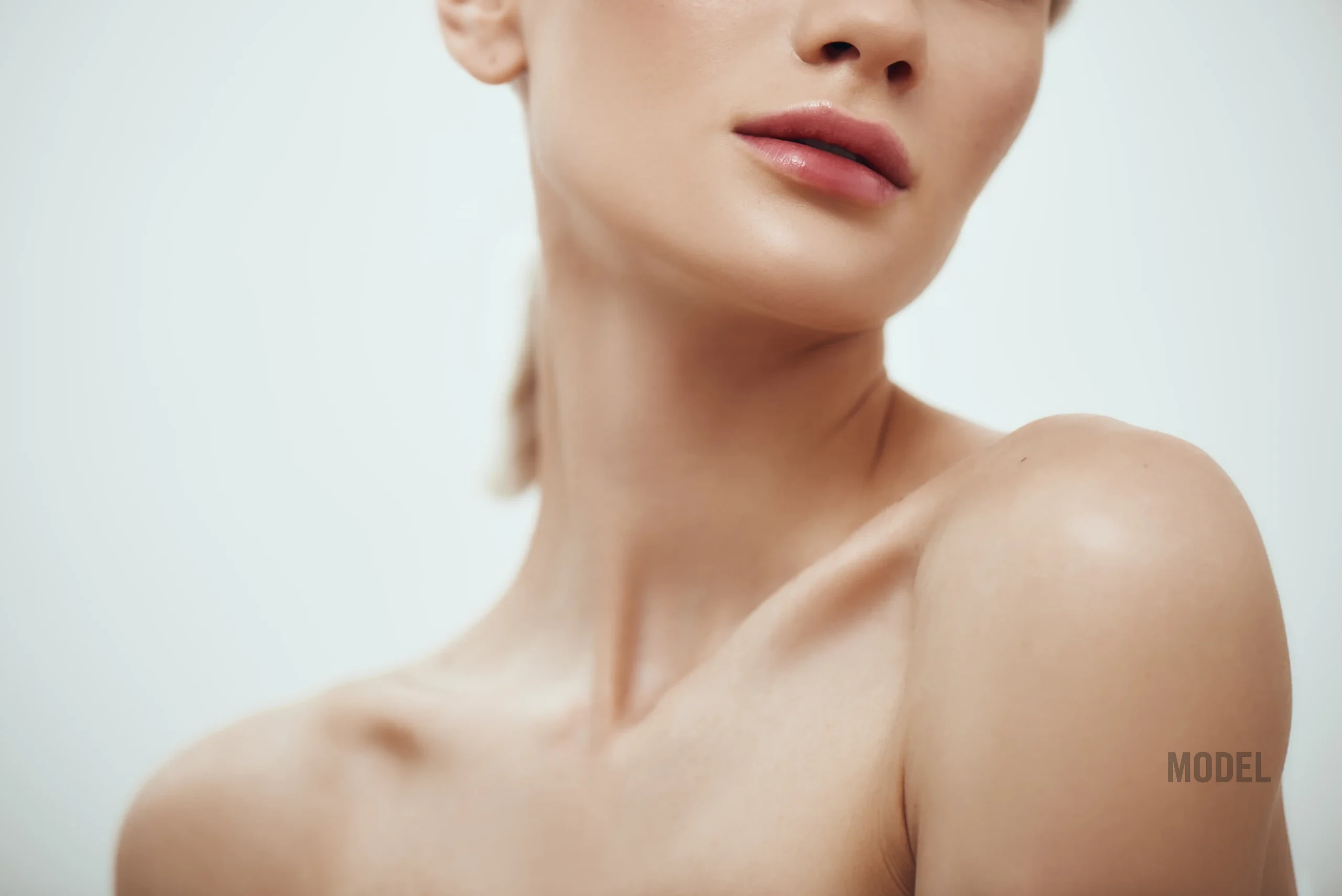 Woman evaluating loose neck skin after significant weight loss