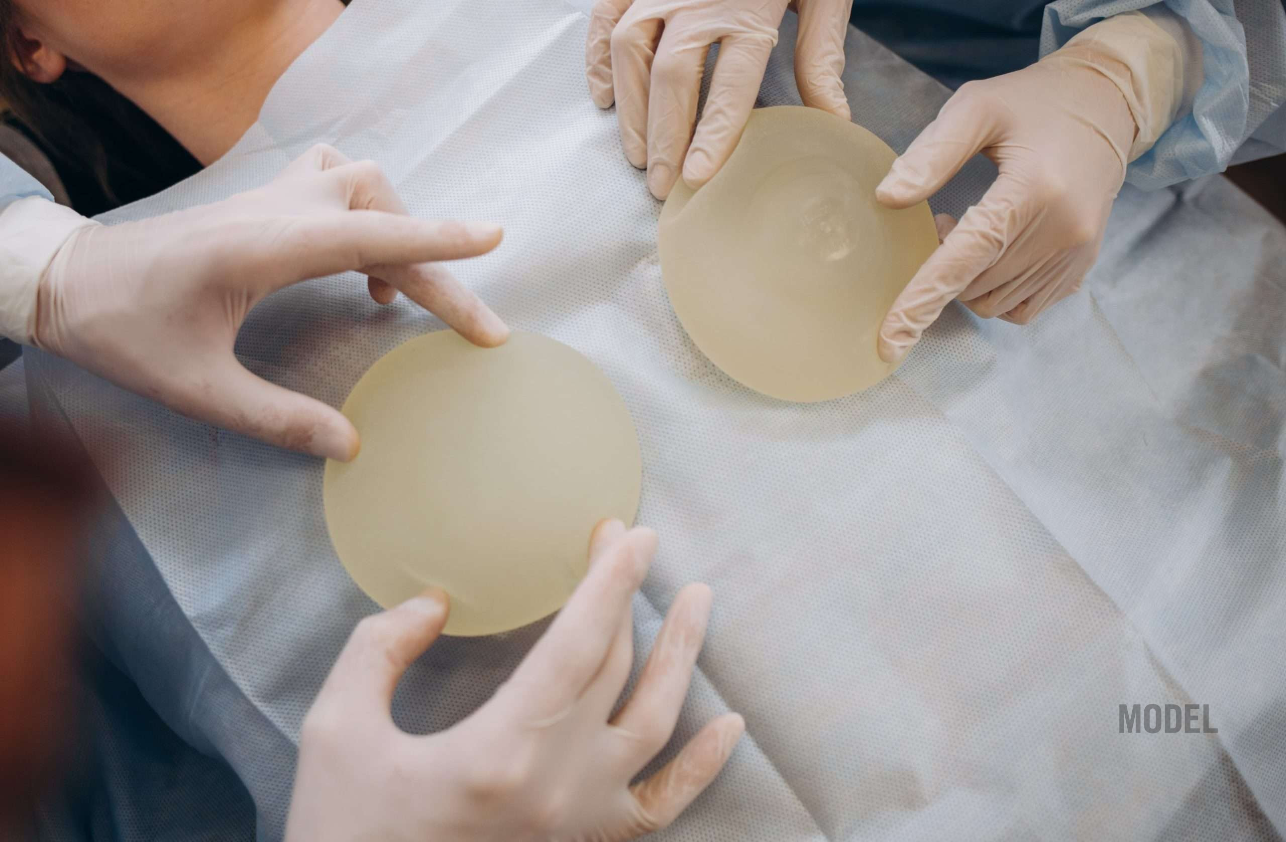 Silicone breast implant options being shown by surgeon