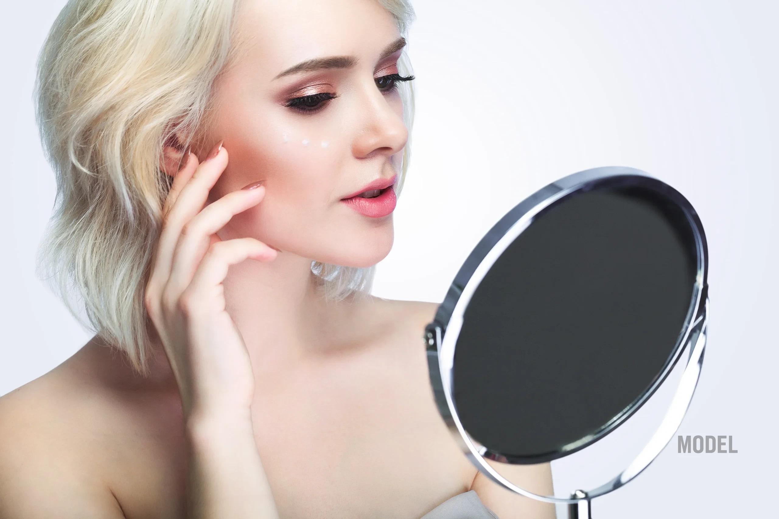 Patient researching how to avoid a bad facelift before choosing a surgeon