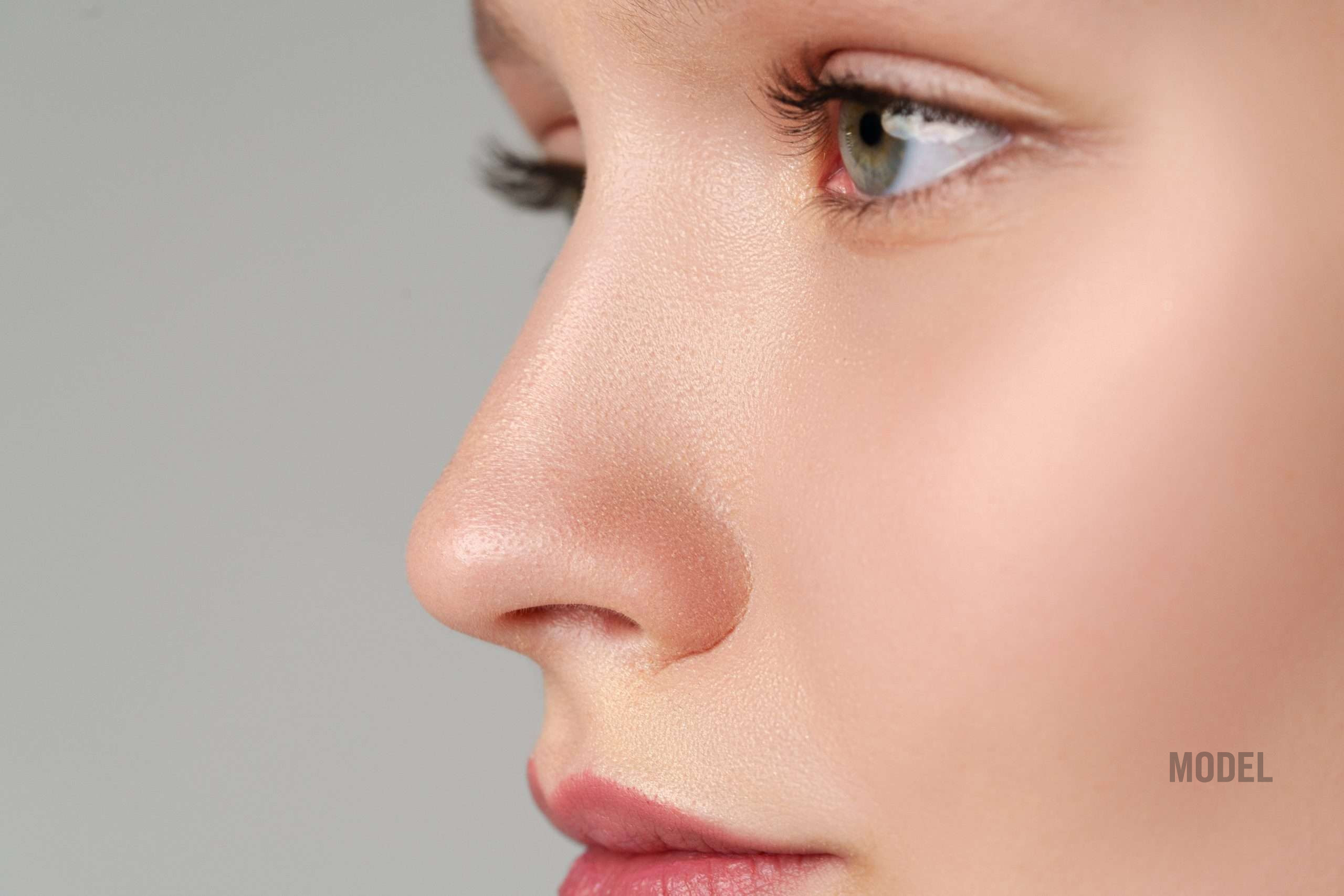 Natural facial balance with refined nasal proportions and soft, harmonious features