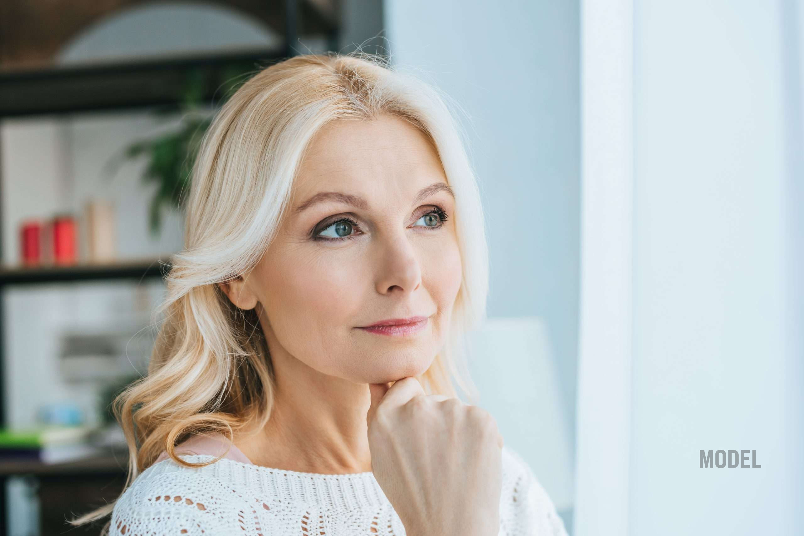 Woman considering how plastic surgery results age over time