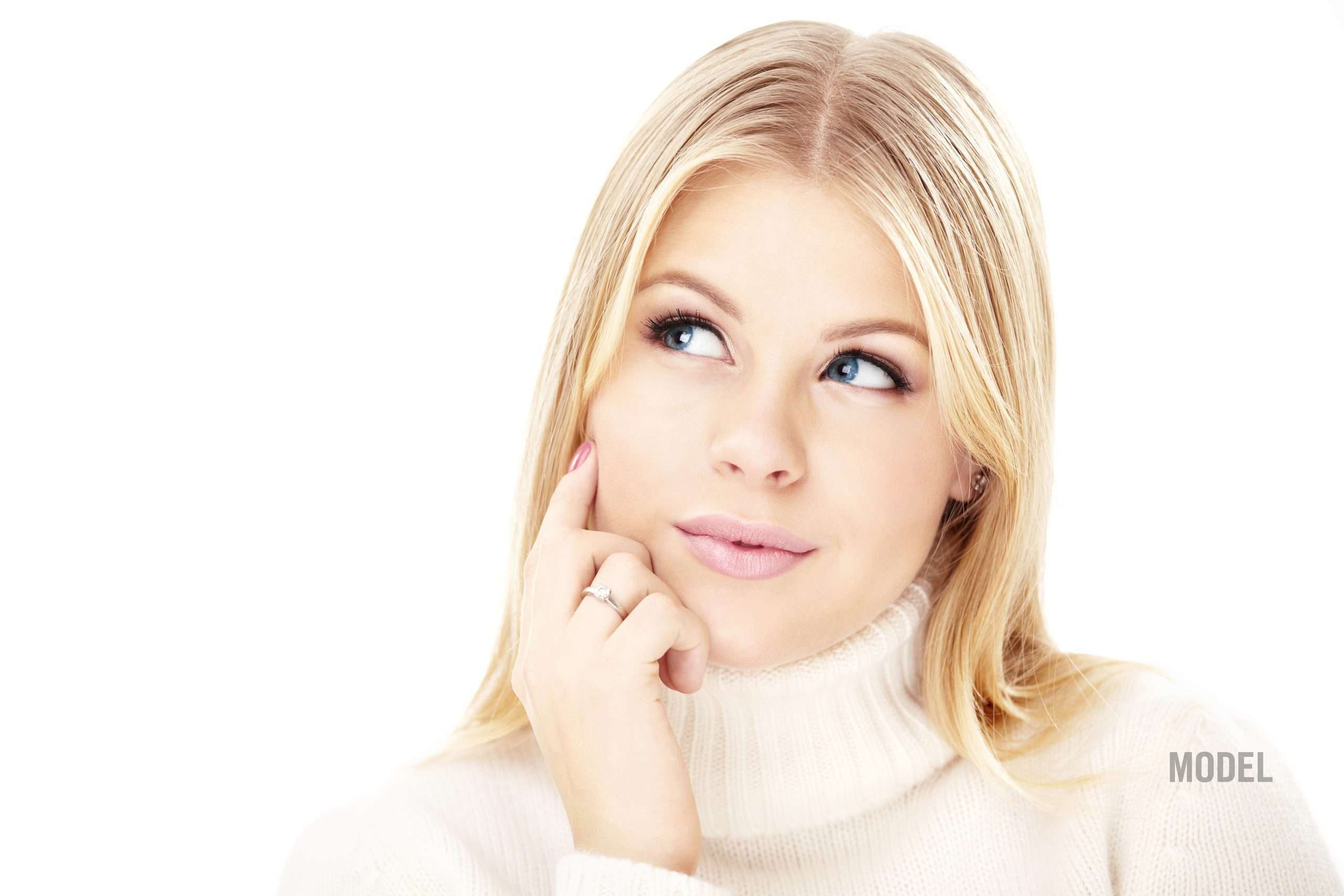 Thoughtful woman considering plastic surgery revision in Santa Monica