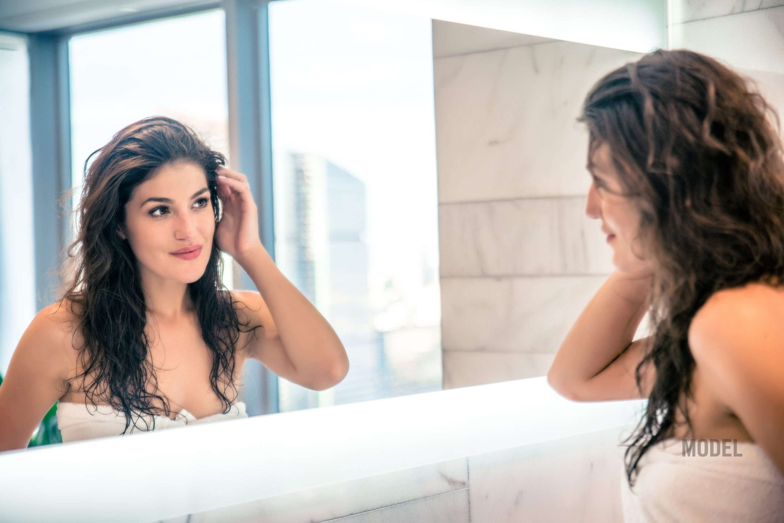 Woman reflecting on facial volume loss and aging changes