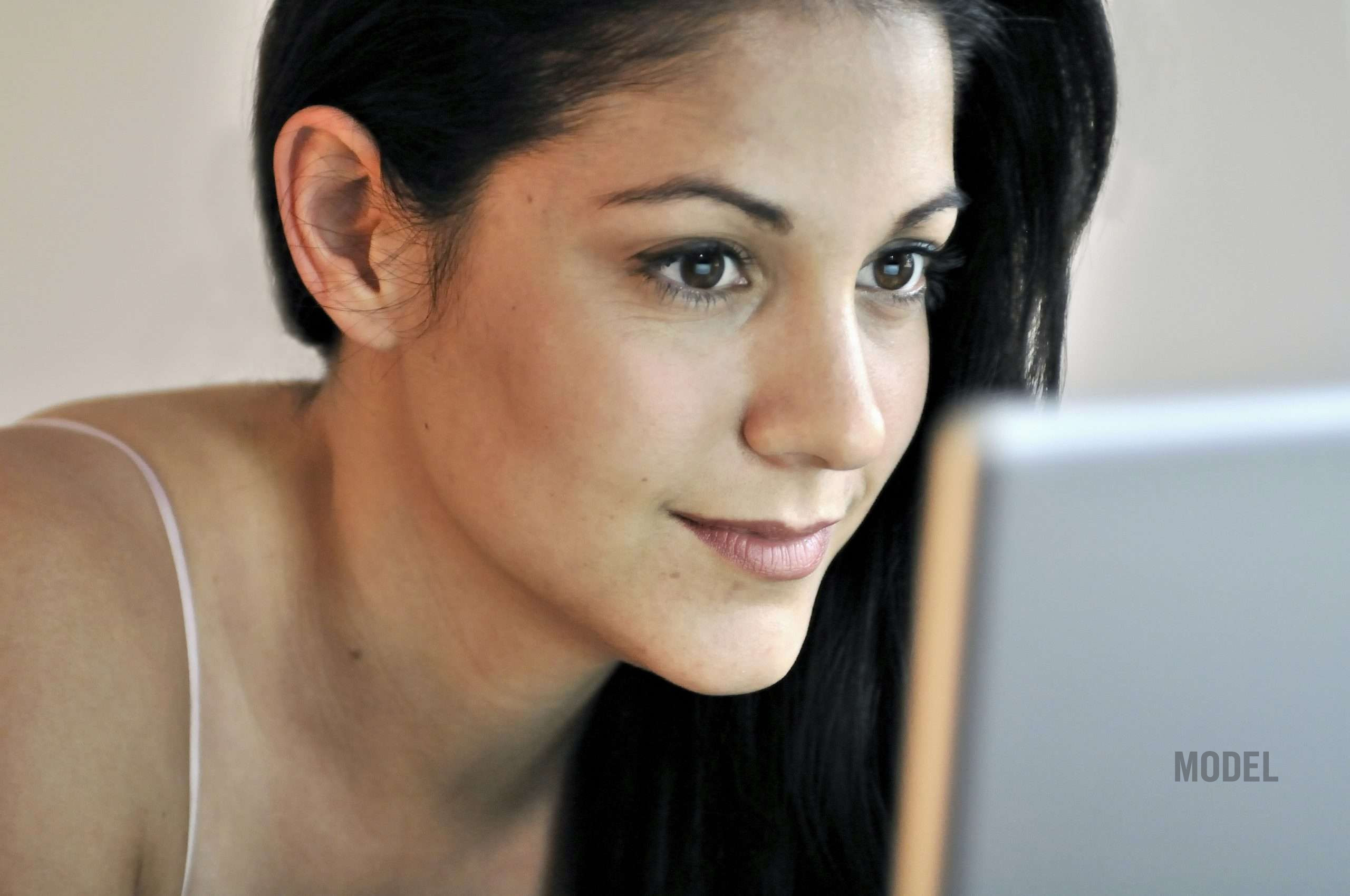 Woman researching how to choose the right plastic surgeon in Santa Monica and Los Angeles
