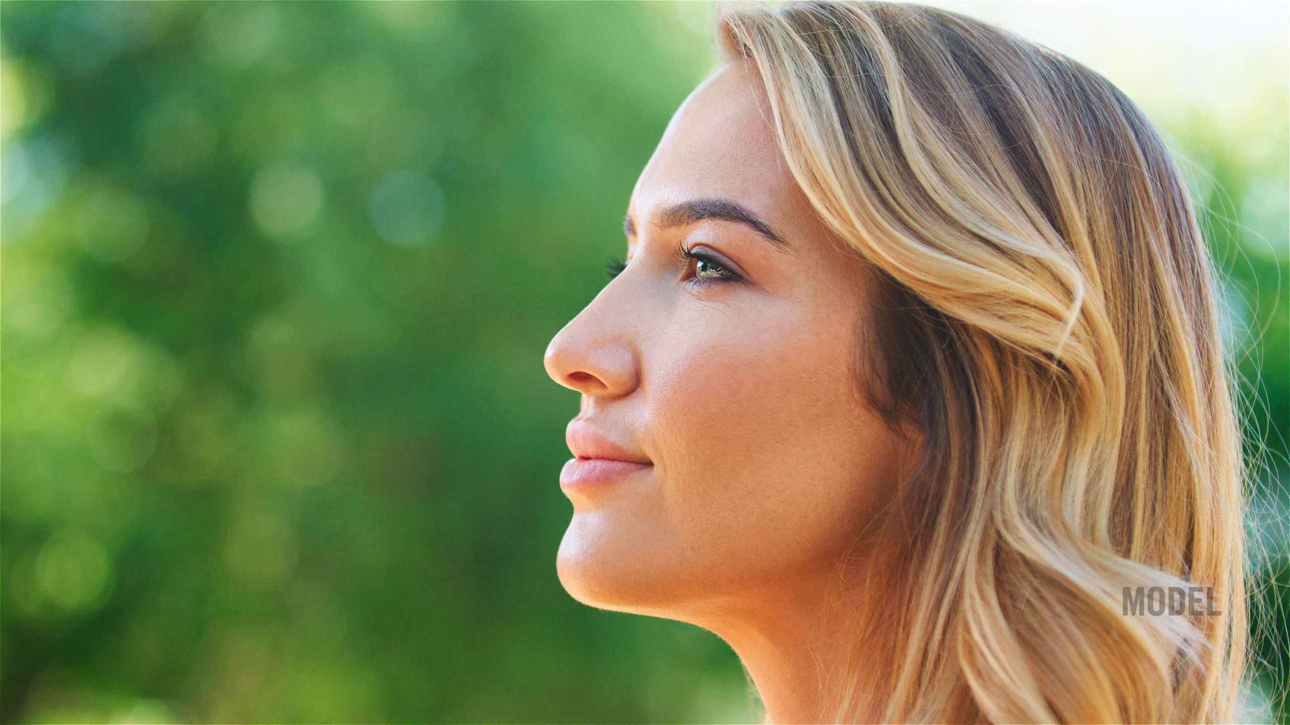 Woman representing subtle and undetectable plastic surgery results