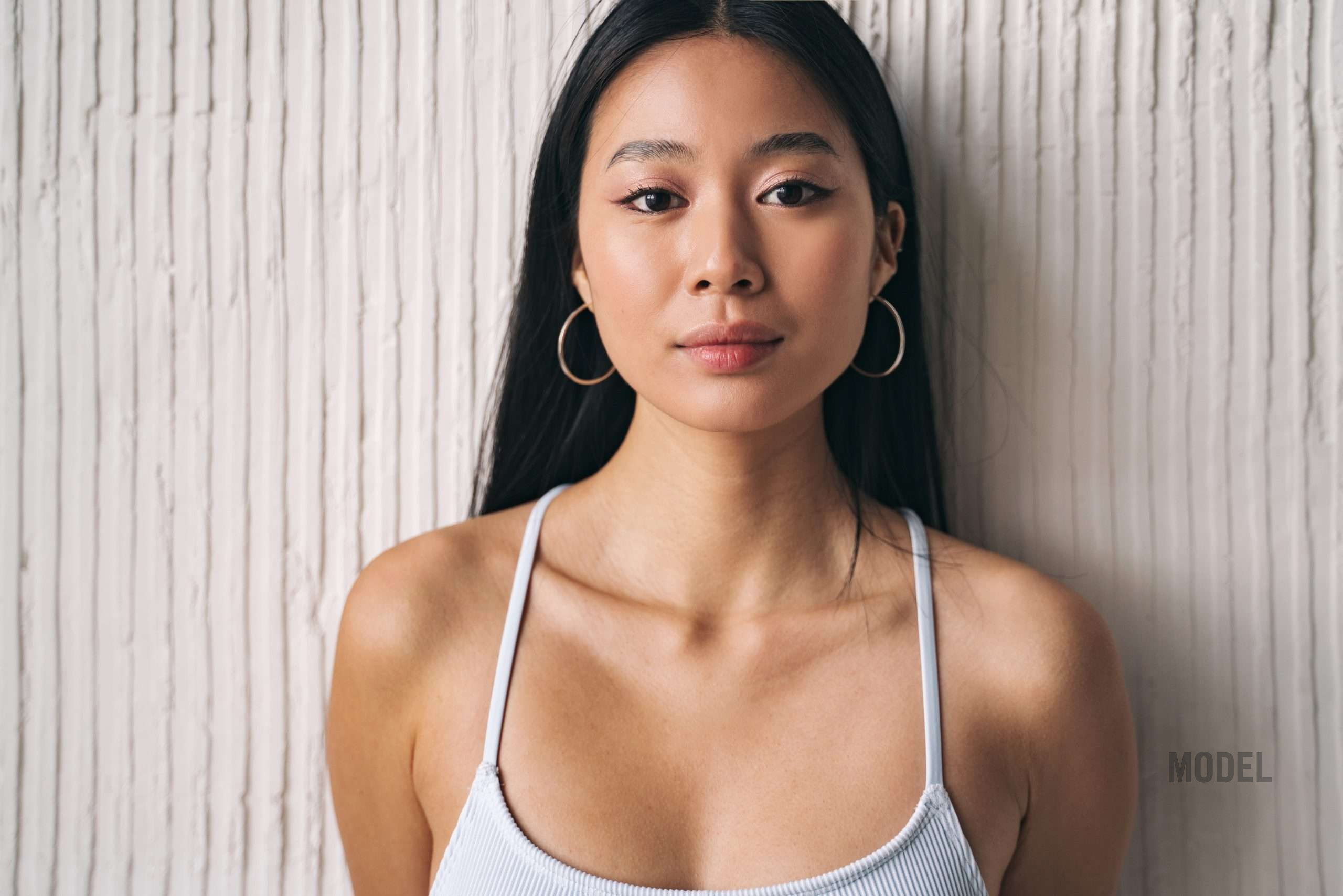 Woman with balanced facial features representing natural Asian rhinoplasty, bridge refinement, tip support, and facial harmony